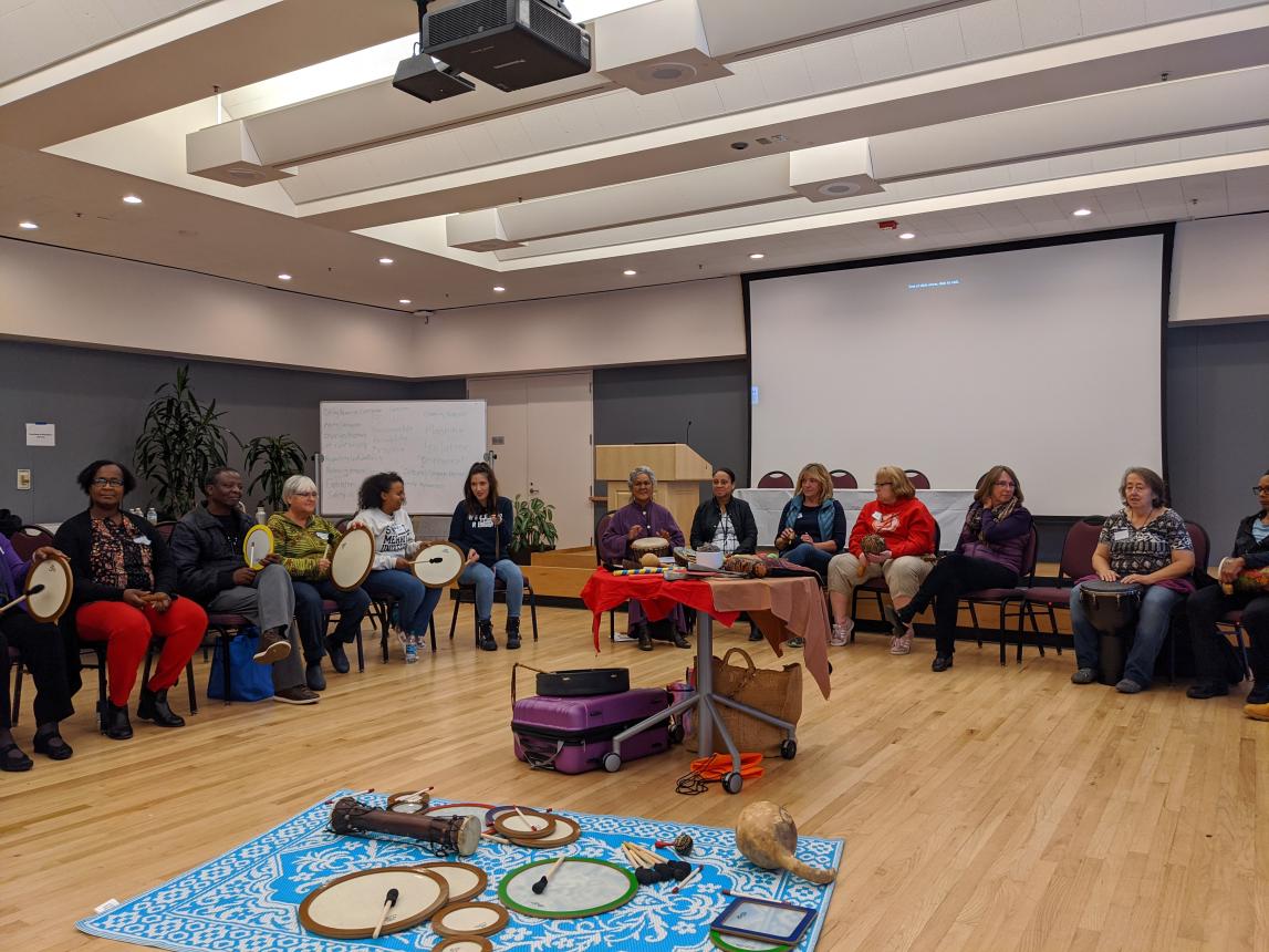 Partcipants of Caregivers Symposium participate in group healing drumming circle