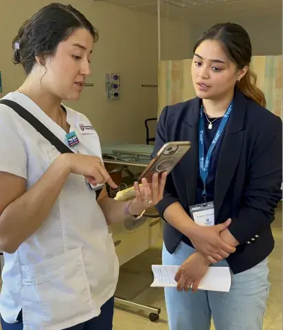 SMU nursing student shows prospective student her phone