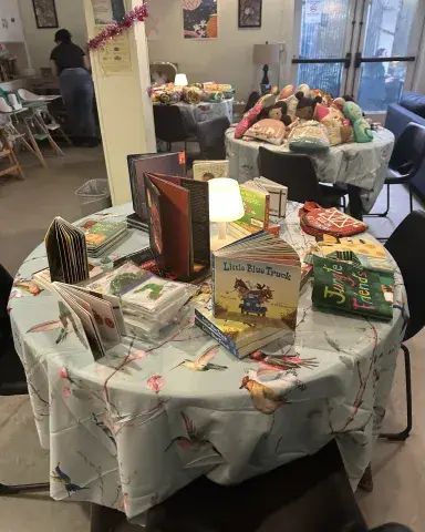 Tables with children's books and Stuffed animals at Jelani House book fair
