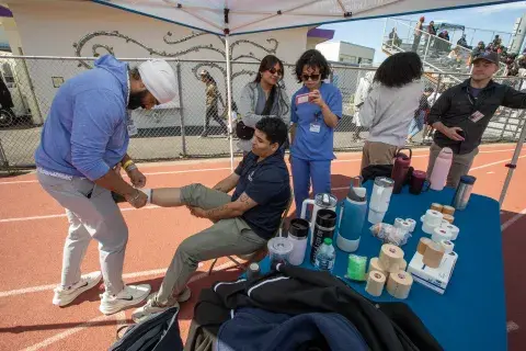 Students practicing ankle taping on each other 