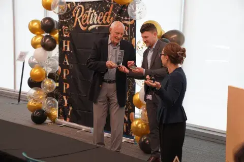 Joel Clark accepting award from Mark Razante