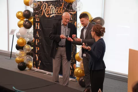 Joel Clark accepting award from Mark Razante