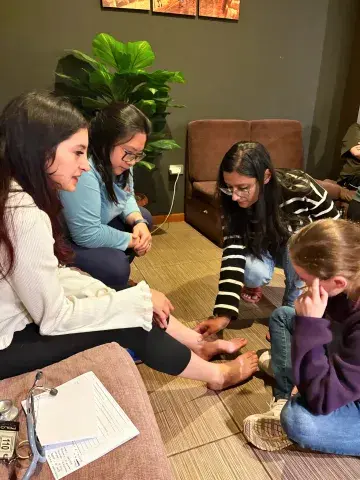 Group of students practicing podiatric medicine with each other