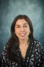 Woman wearing dark floral print shirt
