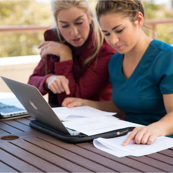 Two female students on laptop
