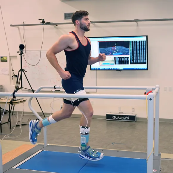 Student running on treadmill in Motion Analysis Research Center