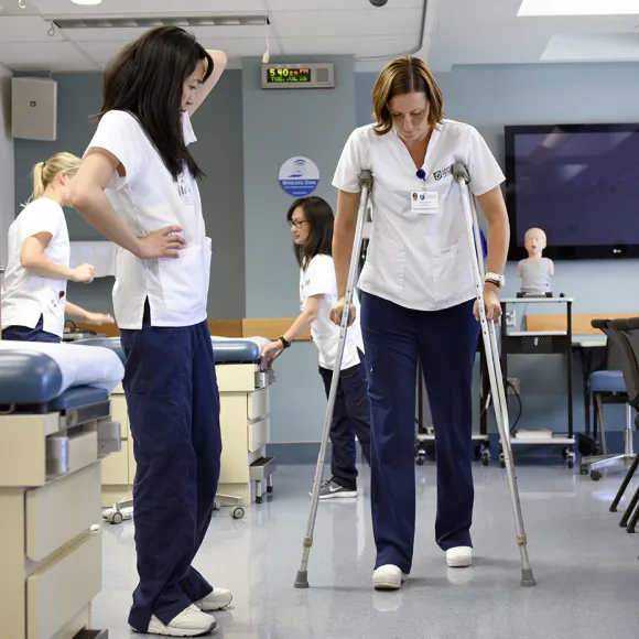 Students working with crutches in Health Sciences Simulation Center