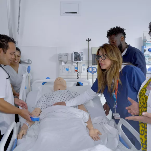 Professor and students working in the simulation center