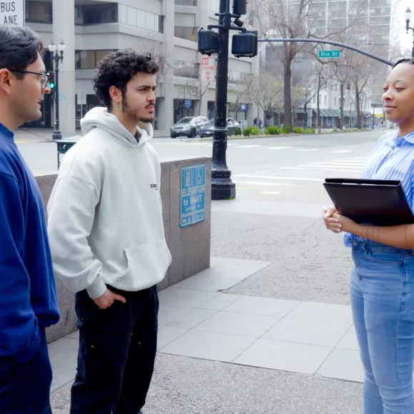 Student and people from community engaging on street