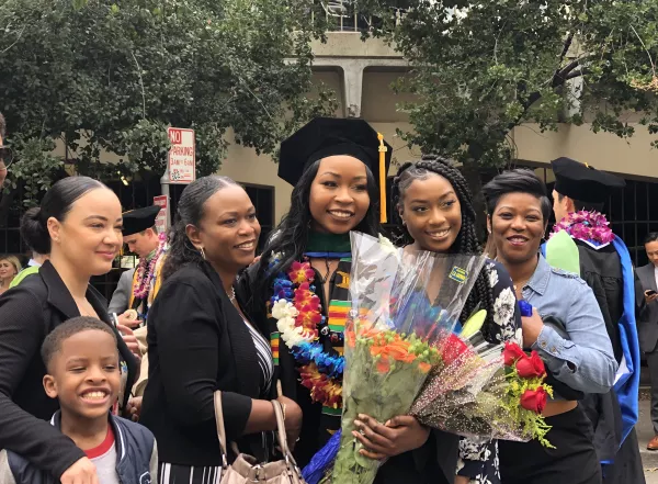 Family posing for picture with daughter on commencement day