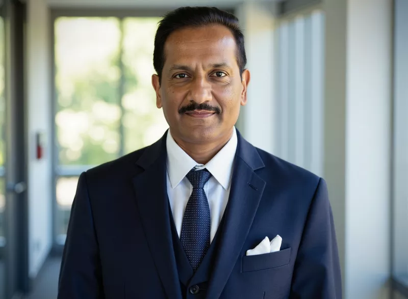 Man standing in a hallway wearing a business suit