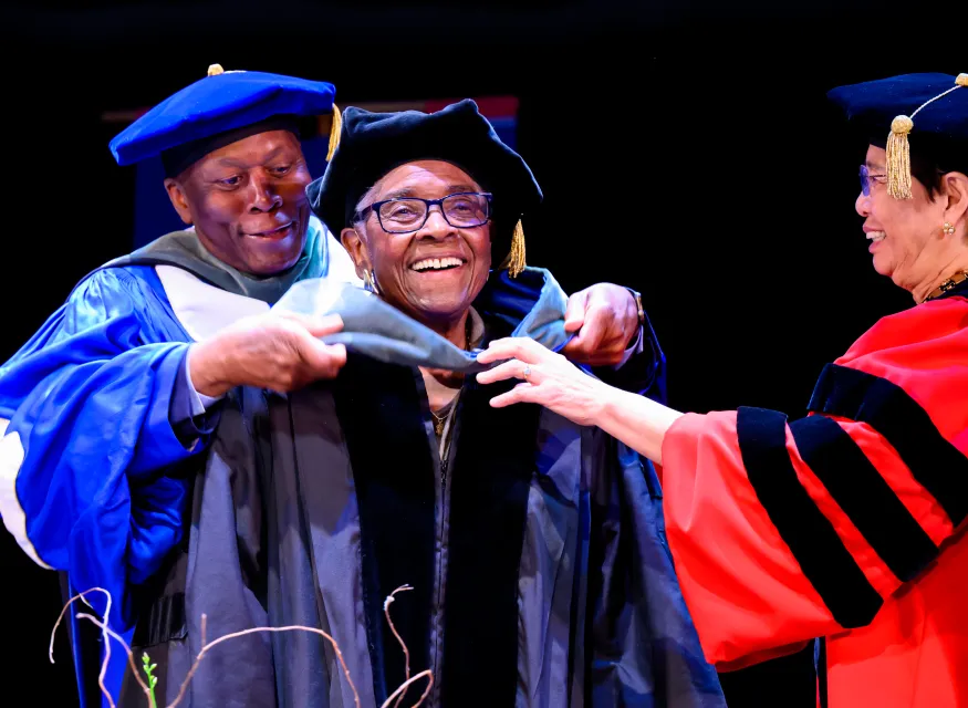 Jovine F. Hankins being hooded by SMU leadership.