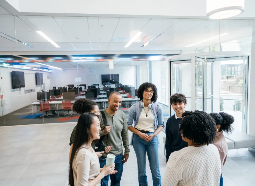 A group of people talking in a classroom