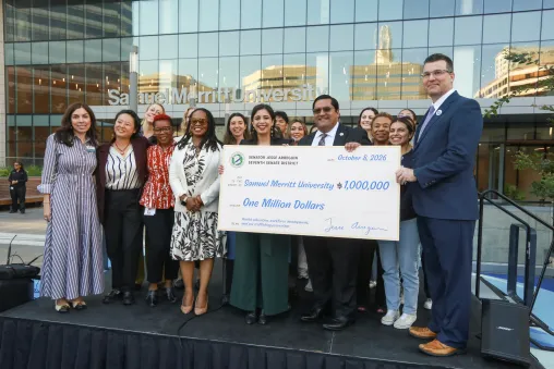 Members of SMU and government officials gather on stage in front of the SMU Oakland campus to accept a $1M check from the State of California for human trafficking response program expansion.