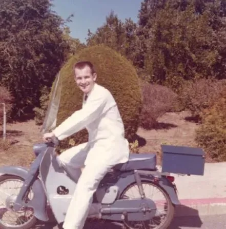 Man on motorcycle wearing a lab coat