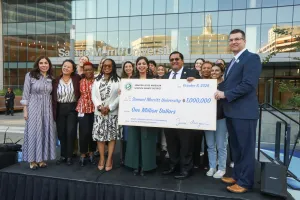 Members of SMU and government officials gather on stage in front of the SMU Oakland campus to accept a $1M check from the State of California for human trafficking response program expansion.