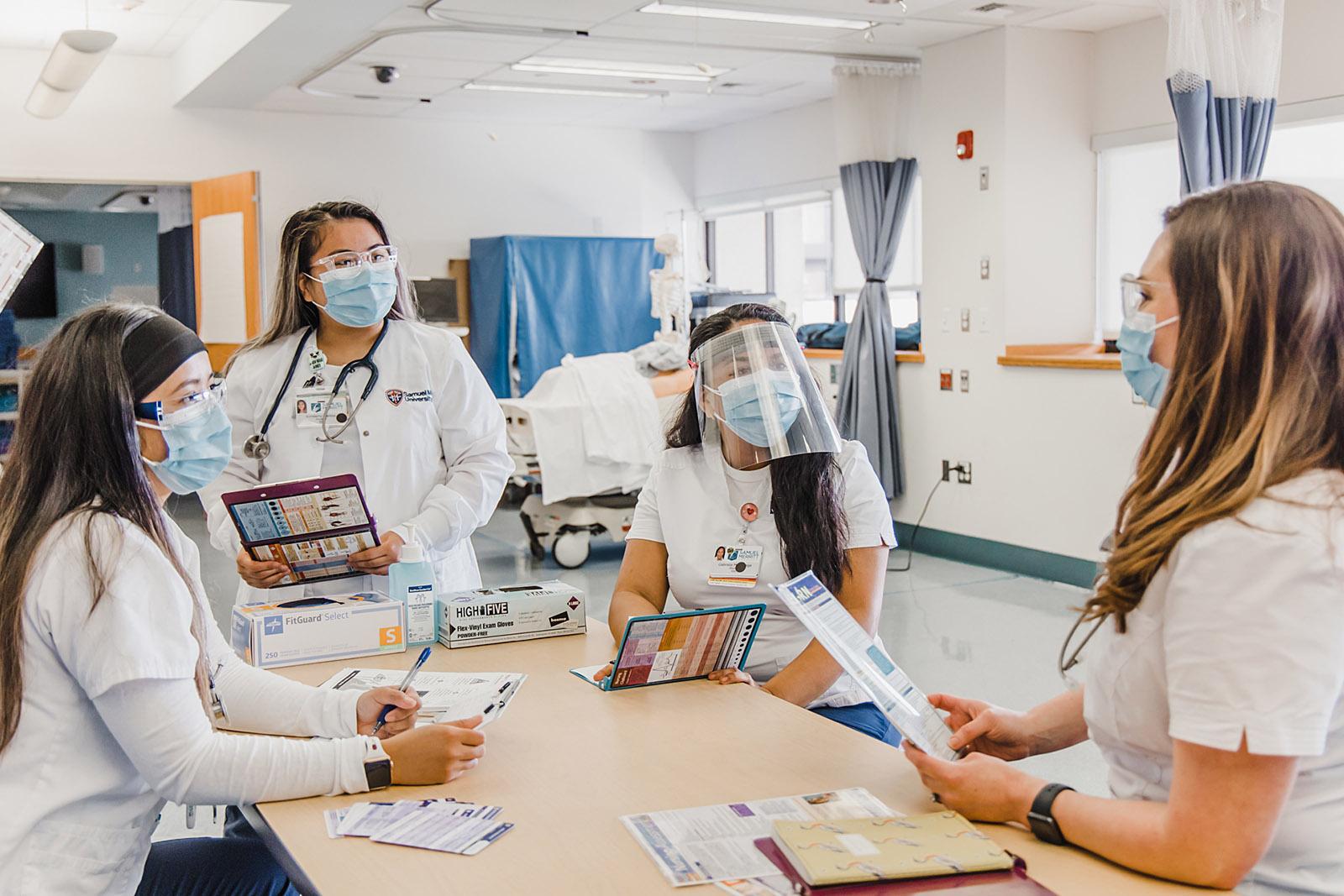 Nursing students with masks around table