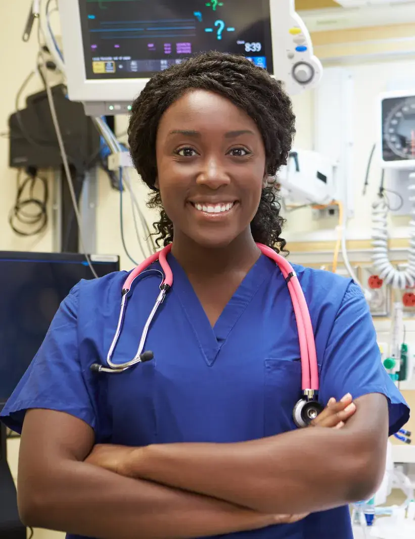 Nurse wearing blue scrubs in a hospital room