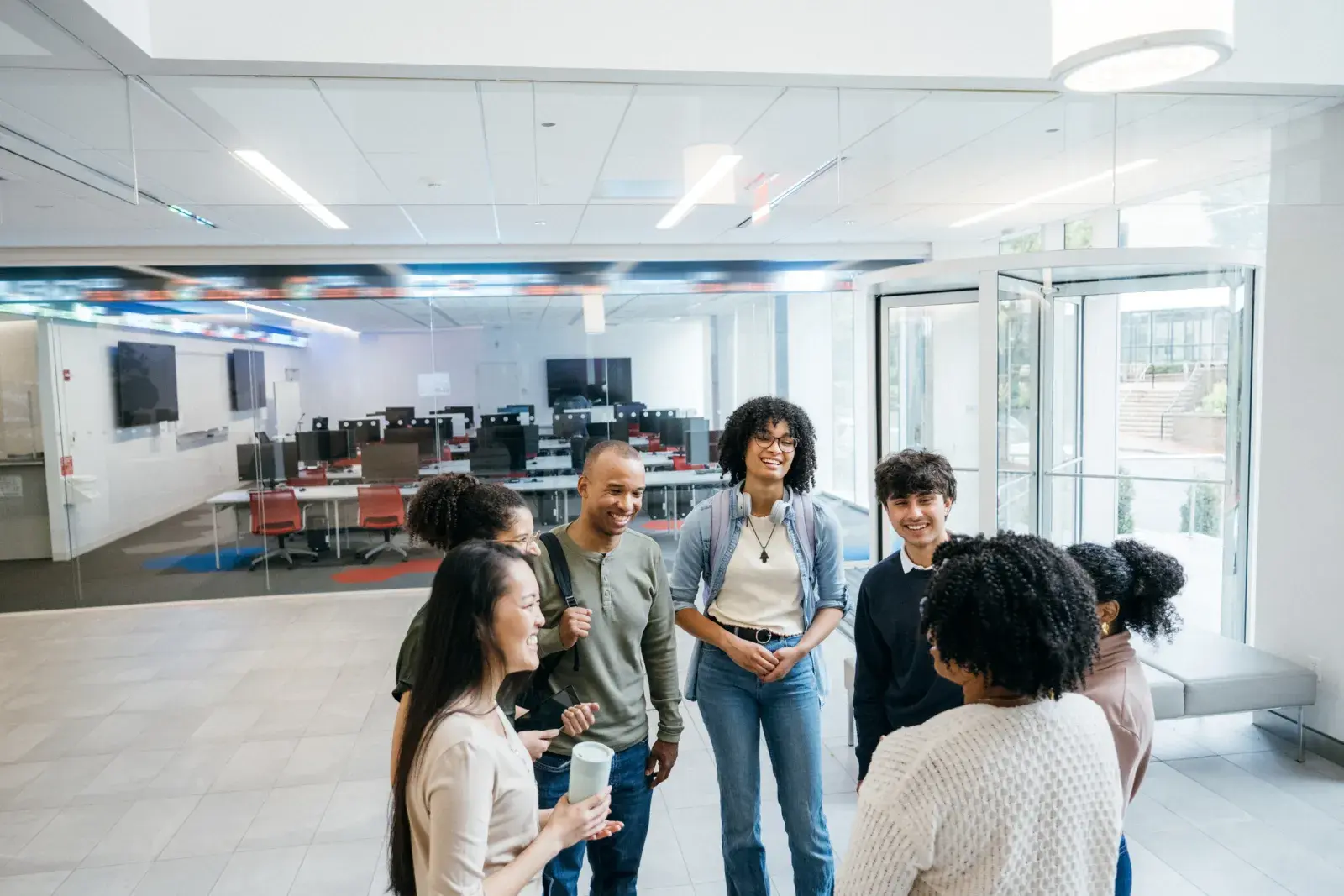 A group of people talking in a classroom