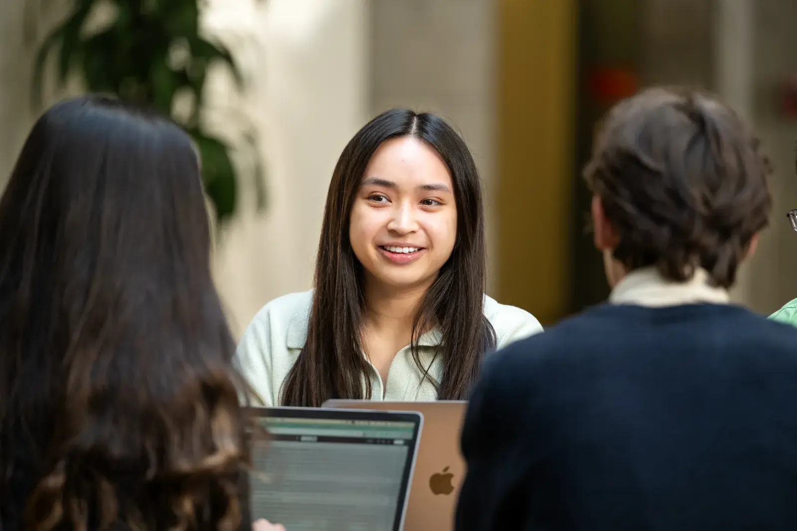 Three students meeting with laptops