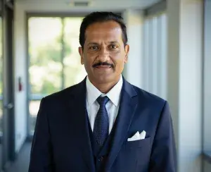Man standing in a hallway wearing a business suit