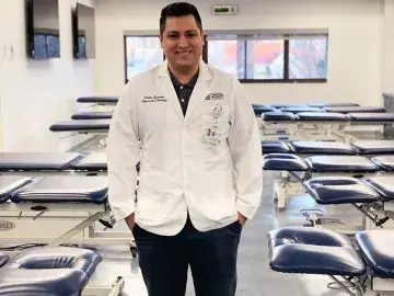 Pablo Tavares, DPT '20, poses in a physical therapy lab