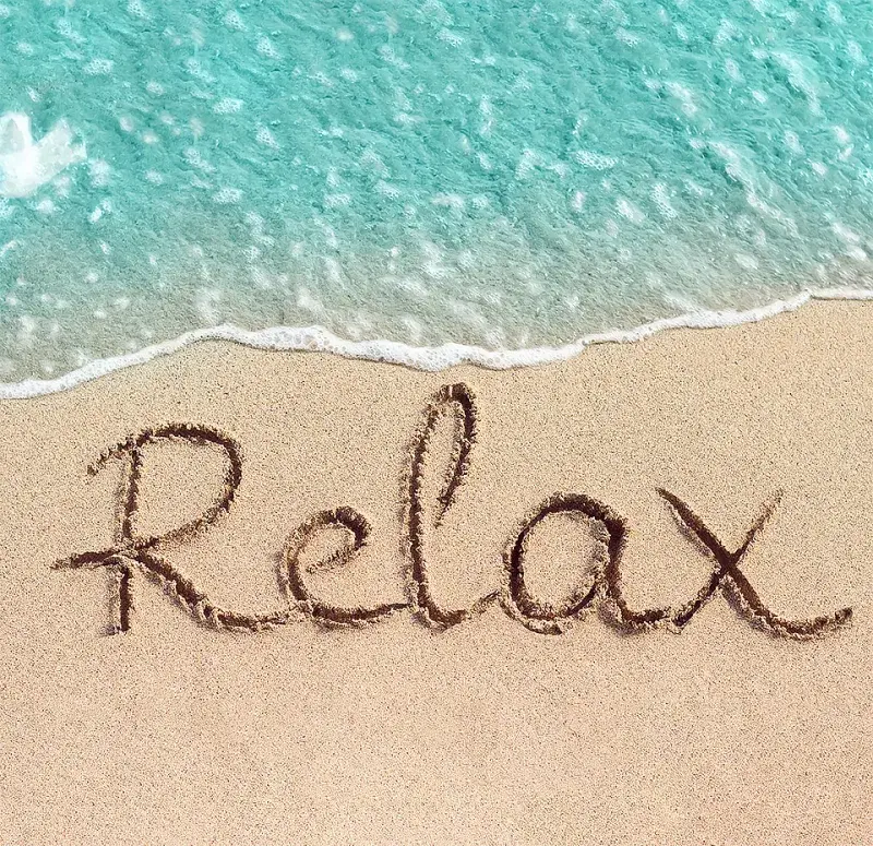 Relax written in the sand