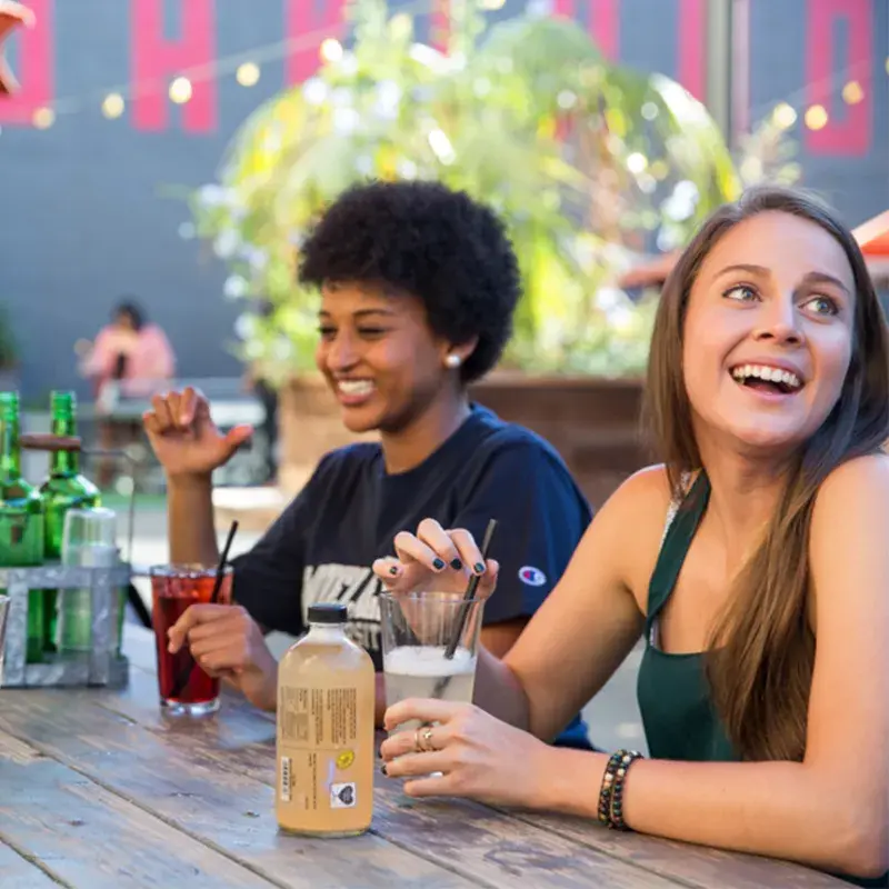two students sitting outside laughing