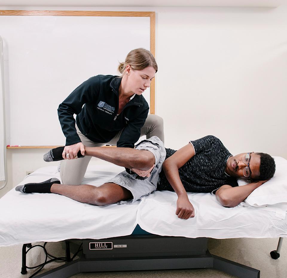 Physical Therapist in lab with patient 