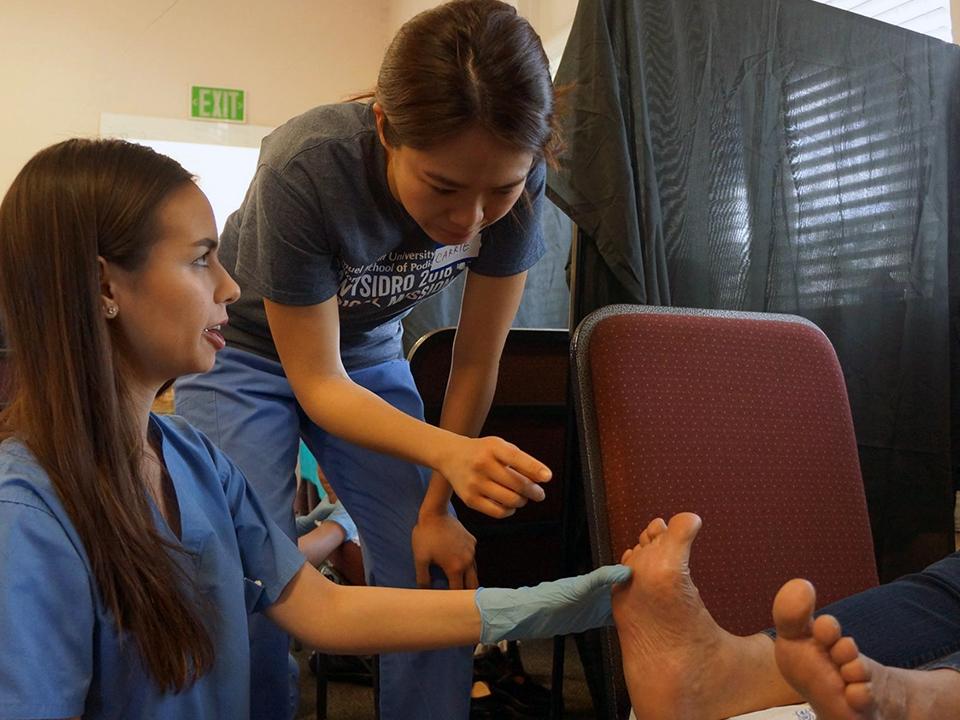 Podiatry students treat a patient in San Ysidro