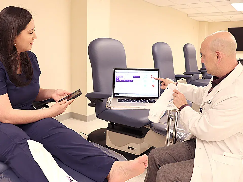 Podiatry Professor Dr. Alexander Reyzelman demonstrates smart socks and associated website and mobile app