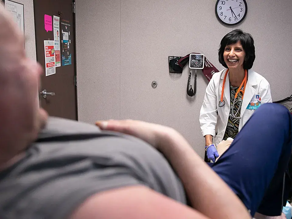 Surani Hayre-Kwan visits with a patient